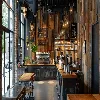 a sophisticated urban cafe features stunning reclaimed wood accents, seamlessly blending modern design with historic charm, illuminated by soft pendant lighting that highlights the space&#x27;s innovative reuse of materials.