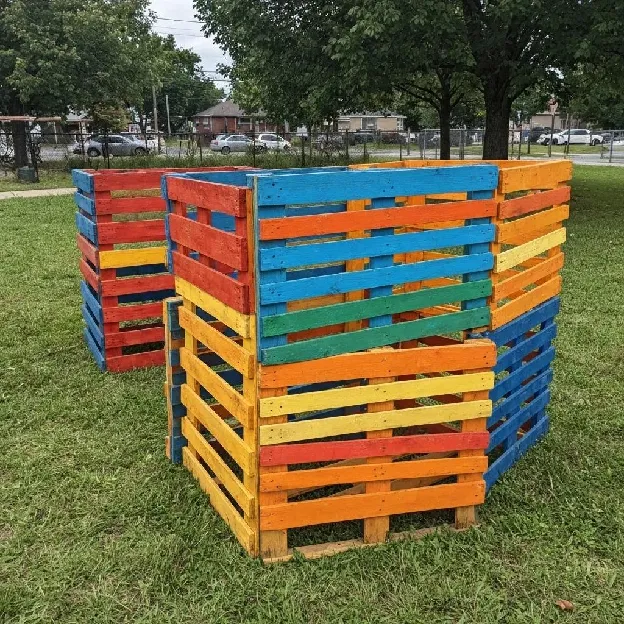Eco-friendly dumpsters labeled for recycling and organic waste in a commercial setting